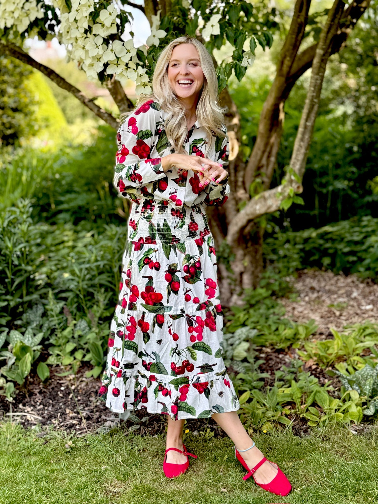 The Rosehip Design Sarah Cotton Shirt is a timeless wardrobe staple, made of soft cotton. It features a classic button-down front, elegant sleeves that end just before the wrist, and a gently curved hem for a relaxed yet polished look.

Featuring our vibrant Barcelona print, this shirt is a celebration of summer, bursting with lively hues and intricate floral patterns. Perfect for warm-weather styling, it pairs beautifully with the matching Sally Skirt for a coordinated ensemble, or just jeans.