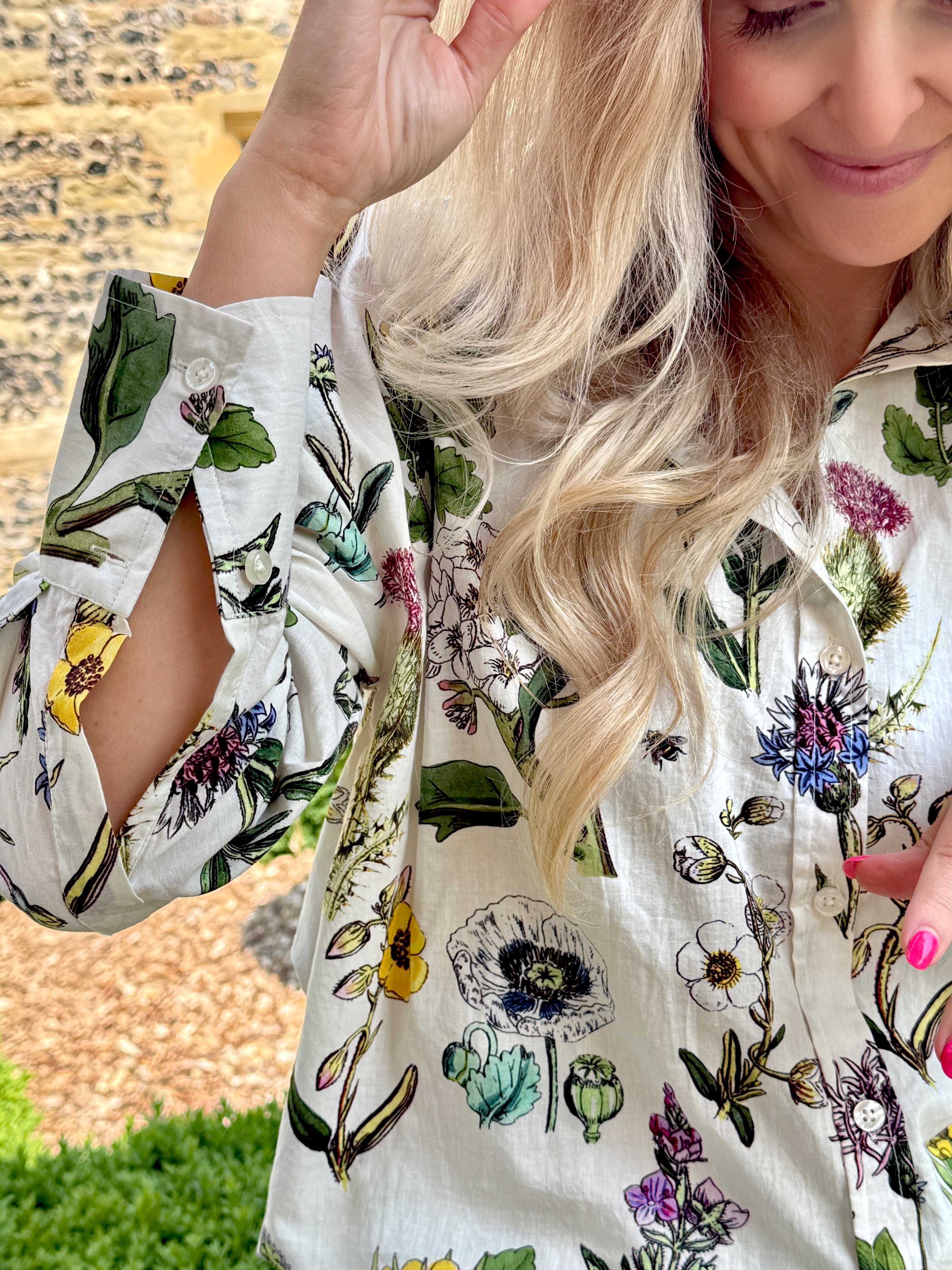 Rosehip Design Sarah Cotton Shirt is a timeless wardrobe staple, made of soft cotton. It features a classic button-down front, elegant sleeves that end just before the wrist, and a gently curved hem for a relaxed yet polished look.

Featuring our spiky Thistle design, this shirt is a celebration of summer, bursting with lively hues and intricate floral patterns. Perfect for warm-weather styling, it pairs beautifully with the matching Sally Skirt for a coordinated ensemble.