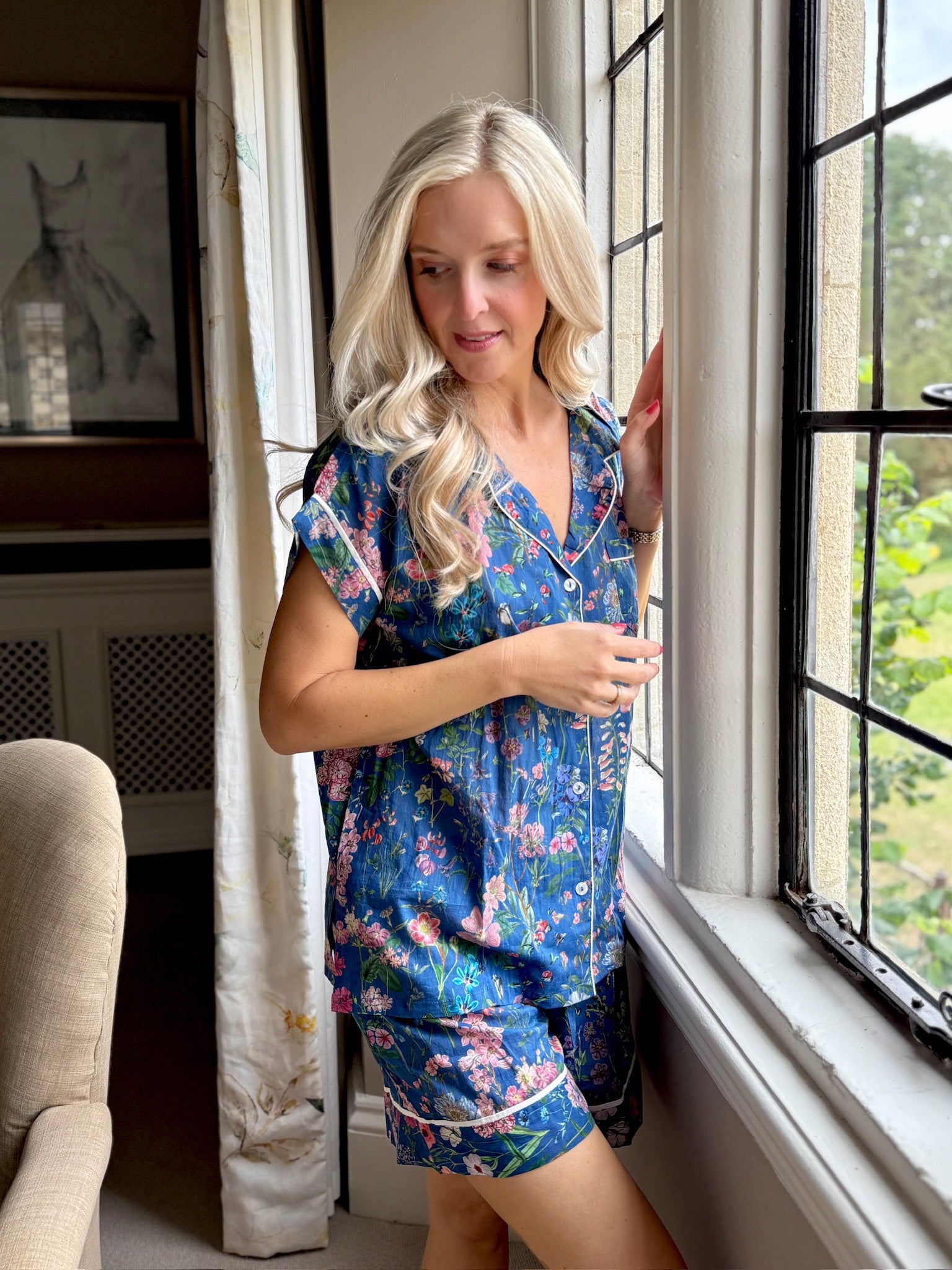 A lovely Rosehip Design short pyjama set in cotton voile with floral print. The top is buttoned with piping detail and the shorts are elasticated and have a drawstring.