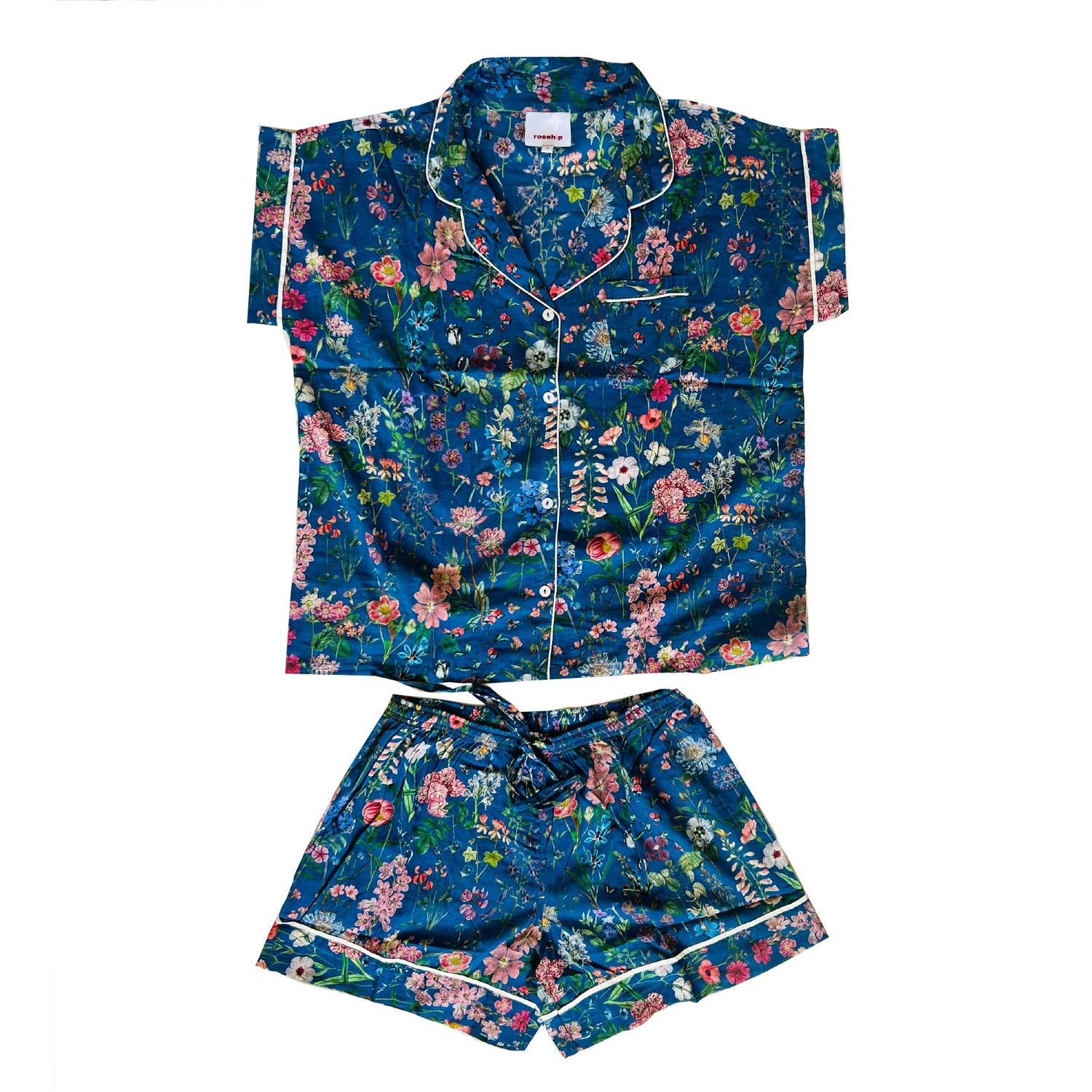A lovely Rosehip Design short pyjama set in cotton voile with floral print. The top is buttoned with piping detail and the shorts are elasticated and have a drawstring.