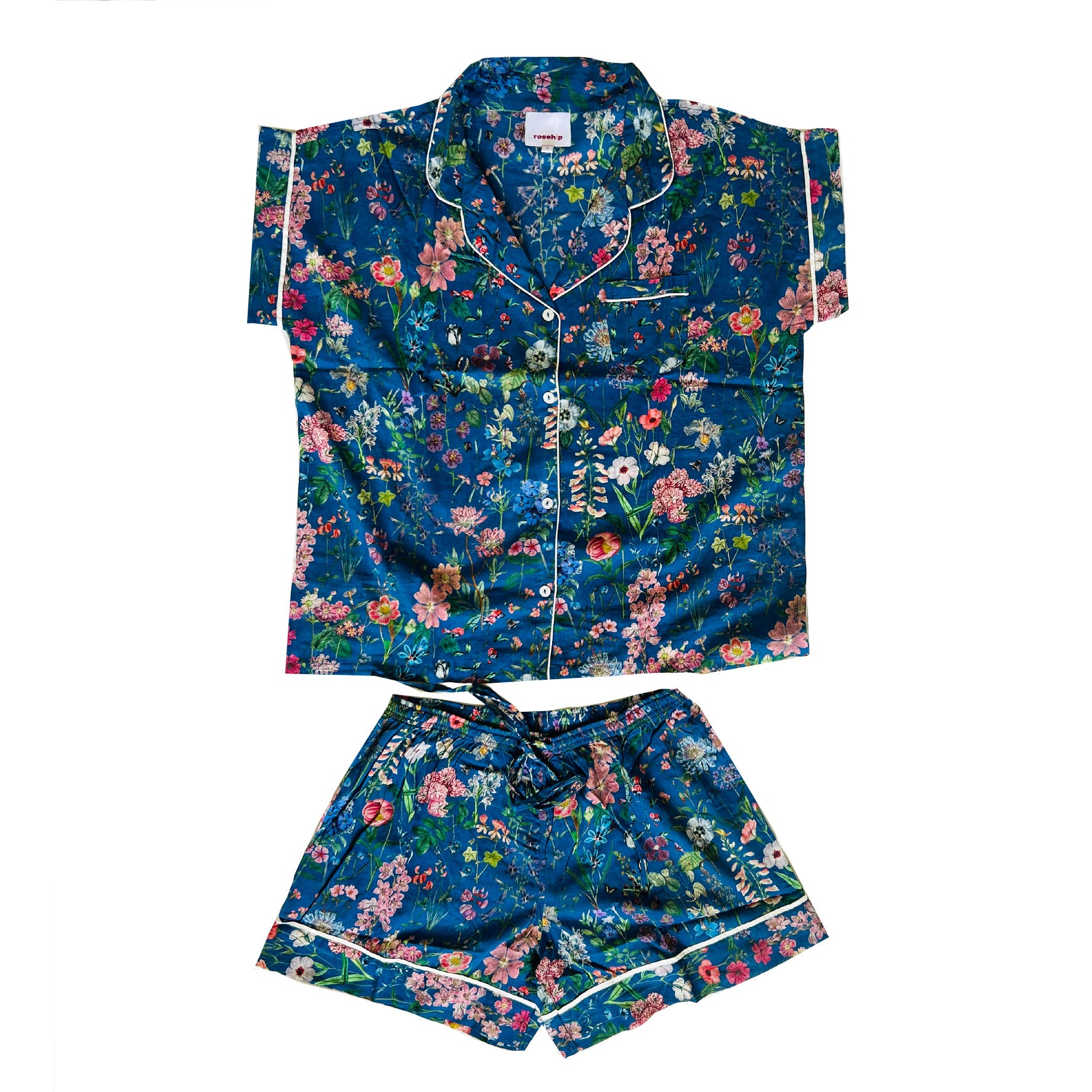 A lovely Rosehip Design short pyjama set in cotton voile with floral print. The top is buttoned with piping detail and the shorts are elasticated and have a drawstring.