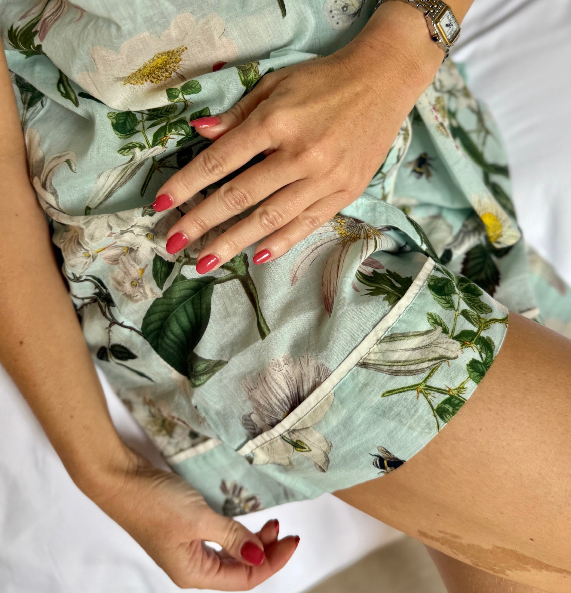 A lovely shirt and short Rosehip Design Pyjama set in cotton voile with floral print. The shirt is buttoned with piping details. The shorts are elasticated and have a drawstring.