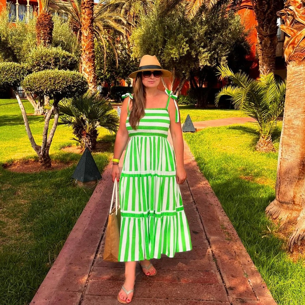 Rosehip Design Tropez Sundress is a gorgeous Summer dress featuring a shirred top with straps and a long flowing skirt with pockets. Perfect holiday wear in our dazzling Verde green and white stripes design.