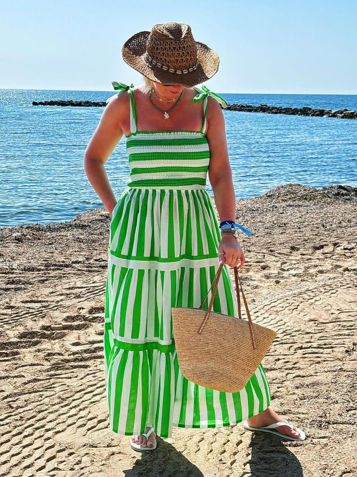 Rosehip Design Tropez Sundress is a gorgeous Summer dress featuring a shirred top with straps and a long flowing skirt with pockets. Perfect holiday wear in our dazzling Verde green and white stripes design.