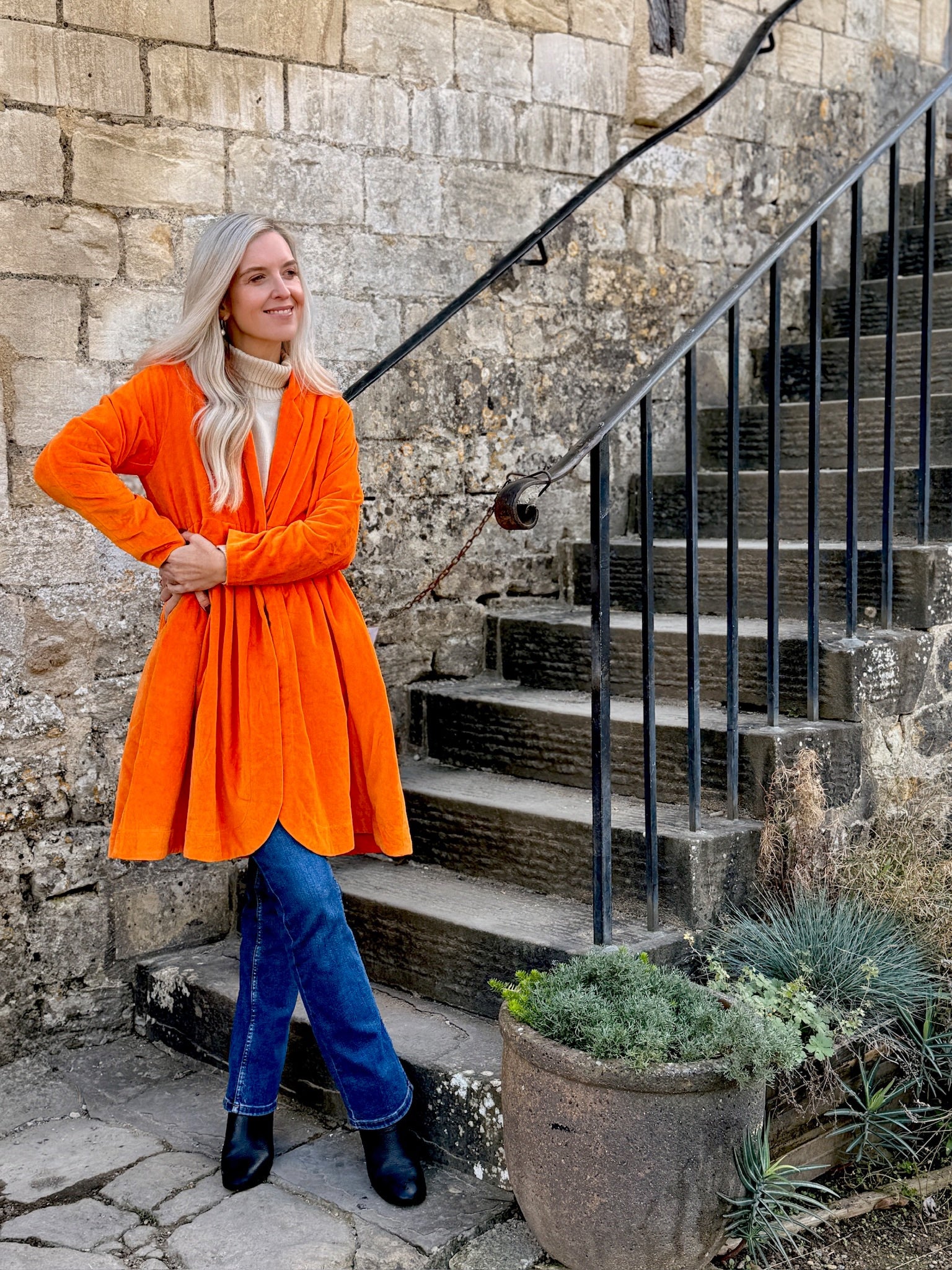 Wrap yourself in autumn warmth with this Rosehip Design statement velvet coat, in a rich, vibrant orange that perfectly echoes the season. The soft velvet exterior is complemented by a classic check lining, adding a touch of timeless style to its bold, modern silhouette. Luxuriously warm yet effortlessly wearable, it’s the perfect layer for crisp autumn days — whether you’re strolling through the countryside or heading into the city.