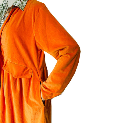 Wrap yourself in autumn warmth with this Rosehip Design statement velvet coat, in a rich, vibrant orange that perfectly echoes the season. The soft velvet exterior is complemented by a classic check lining, adding a touch of timeless style to its bold, modern silhouette. Luxuriously warm yet effortlessly wearable, it’s the perfect layer for crisp autumn days — whether you’re strolling through the countryside or heading into the city.