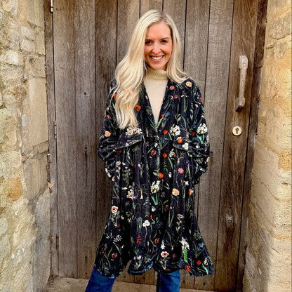 Wrap yourself in autumn warmth with this statement velvet coat, in a rich, vibrant orange that perfectly echoes the season. The soft velvet exterior is complemented by a classic check lining, adding a touch of timeless style to its bold, modern silhouette. Luxuriously warm yet effortlessly wearable, it’s the perfect layer for crisp autumn days — whether you’re strolling through the countryside or heading into the city.