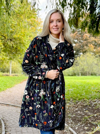 Wrap yourself in autumn warmth with this statement velvet coat, in a rich, vibrant orange that perfectly echoes the season. The soft velvet exterior is complemented by a classic check lining, adding a touch of timeless style to its bold, modern silhouette. Luxuriously warm yet effortlessly wearable, it’s the perfect layer for crisp autumn days — whether you’re strolling through the countryside or heading into the city.