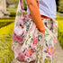 Person holding a Rosehip floral Gallerie bag outdoors